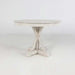 Small round white dining room table perfect for coastal kitchens.